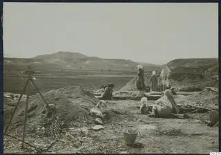 Women and a child working in an excavation at Marion, with a white dog lying on the spoil heap.