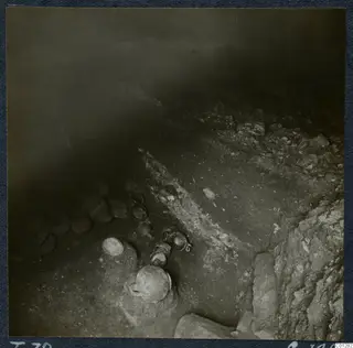 Tomb 39 at Marion during excavation, with pottery vessels lying in situ among stones