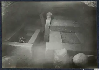 Tomb 53 at Marion during excavation, showing rock-cut ledges with pottery vessels in place