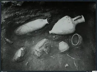 Tomb 60 at Marion during excavation, with pottery vessels and sherds lying on the tomb floor