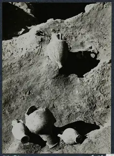 Pottery vessels lying in situ on an excavated earth surface at Marion, Tomb 59