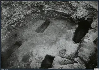Tomb 58 at Marion during excavation, with stones in the foreground