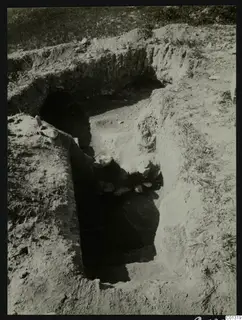 Tomb 15 at Marion during excavation, with a sloping cut leading down to the dark tomb entrance.
