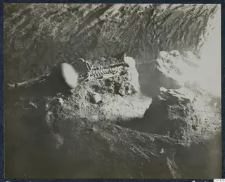Skeleton and pottery vessels lying in the interior of Tomb 72 at Marion