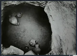 Marion Tomb 71 interior, with pottery vessels lying on the chamber floor