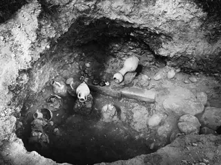 Tomb 67 at Marion, interior, with pottery vessels lying on the floor of the excavated chamber