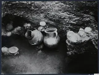 Pottery vessels in situ inside rock-cut Tomb 69 at Marion during excavation
