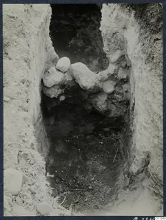 Excavated trench at Marion with rough stones and loose soil on its sides, seen from above.