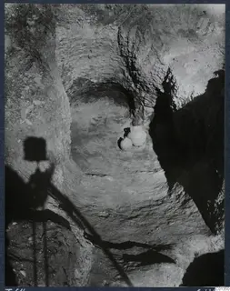 Tomb 64 at Marion during excavation, with two jars resting on the cut floor of the rock-cut chamber.