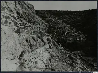 Rocky hillside with stone terraces and a small building in a valley on the Karpas peninsula.