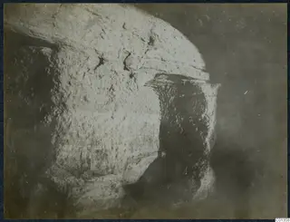 Large rough-surfaced stone block with an overhanging ledge, from an excavation on the Karpas peninsula