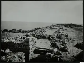 Stone foundations and a stepped feature at Nitovikla on the Karpas, with the sea beyond.