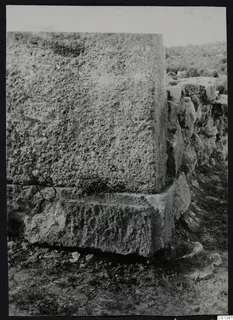 Large squared stone blocks in a wall at Nitovikla, with a low wall running off to the right.