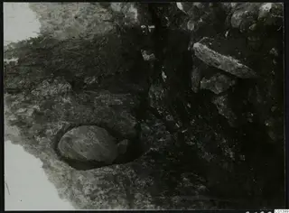 Nitovikla, Karpas Peninsula: stones exposed during excavation, with a rounded stone set in a cut in the soil