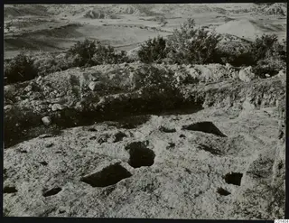 Rock-cut hollows in the surface of the cult place beneath Tomb 1 at Palaeoskoutella, seen from the east