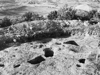 Cut hollows in bedrock at the cult place beneath Tomb 1 at Palaeoskoutella, seen from the east
