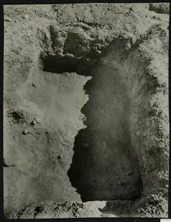 Excavation at Nitovikla, a rectangular cut in the soil with stones visible around its edges