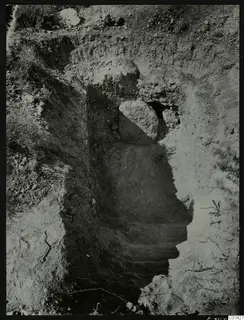 Excavated sloping cut in stony ground with a large stone at its upper end, exterior of Tomb 2 at Kountoura Trachonia