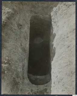 Tomb 11 at Ayios Iakovos, narrow excavated tomb chamber cut into soil