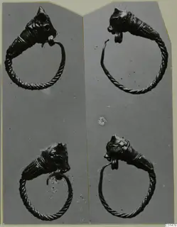 Four twisted-wire rings with cone-shaped ridged heads, photographed in two rows of two on a grey backing.