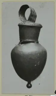 Gold pendant from Marion with a ribbed loop at the top and a small ball at the base