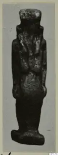 Small standing figure from Marion Tomb 50, shown upright against a plain grey background