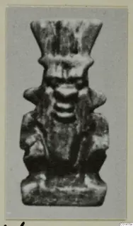Small figure amulet with a tall flaring headdress, from Marion Tomb 50