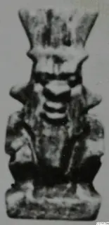 Small standing figure with a tall flared headdress and arms at its sides, from Marion Tomb 50