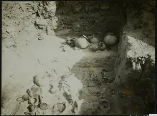 Excavation pit at Nitovikla with pottery vessels and broken sherds lying in situ on the floor of the cut