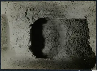 Dark opening cut into a pale sandy wall during excavation on the Karpas peninsula