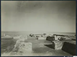 Ruined stone walls and foundations at the palace at Vouni, with a flat horizon beyond.