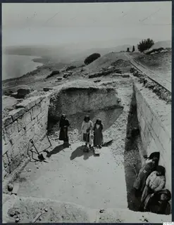 Room 93 at Vouni during excavation, with three people standing in the trench and others seated against the right-hand wall.