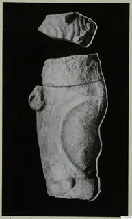 Two limestone sculpture fragments from Vouni, one above the other, photographed against a black background.