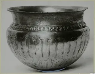 Silver vessel from Vouni 292 with a flared rim and embossed lobed decoration on the body