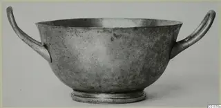 Silver cup from Vouni with two looped handles and a ring foot, shown in side view.