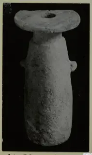 Alabaster vessel with a wide flat disc-shaped top and two small lugs on the body