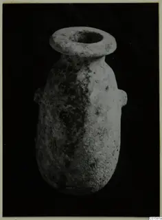 Alabaster vase from Vouni with a wide flared rim and two small handles, shown against a black background