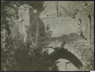 Ruined stone walls and a pointed-arched opening among trees in the Kyrenia Mountains