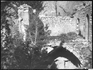 Ruined stone walls, a pointed-arch opening and a vaulted arch among trees in the Kyrenia Mountains