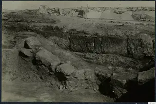 Excavated area at Vouni palace with large cut stone blocks and layered earth banks