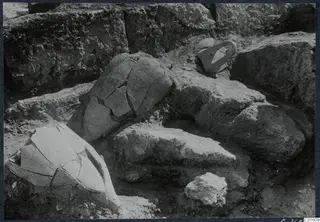 Broken pottery vessel and a loop handle lying in situ in an excavation at Vouni