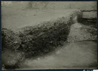 Excavated soil section beside a stone wall during excavation at the palace at Vouni