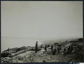 Workers on the eastern slope at Vouni above the sea, with tip wagons on a narrow rail track