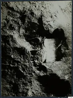 Close view of finds in situ at Vouni: a pale stone set into a pitted, rough excavated surface