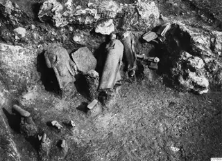 Draped stone statues and column drums lying in situ in an excavated area at Vouni Palace