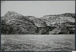 Scrub-covered hills and rocky slopes rising above the sea at Vouni