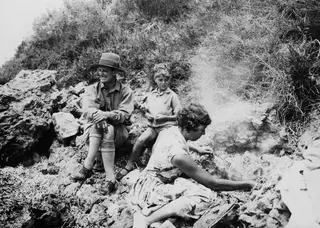 The Gjerstad family seated and kneeling on rocks at Petra tou Limniti