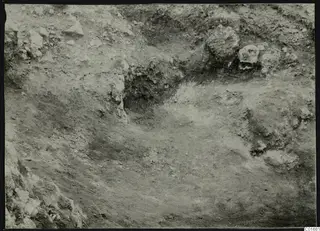 Excavation at Petra tou Limniti showing exposed stones and dug soil in a trench.