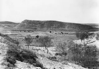 The Acropolis of Idalion seen from the east: a long flat-topped hill with stepped, banded slopes