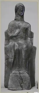 Seated terracotta figure on a rectangular base, with a high-backed seat and cracks across its grey surface.